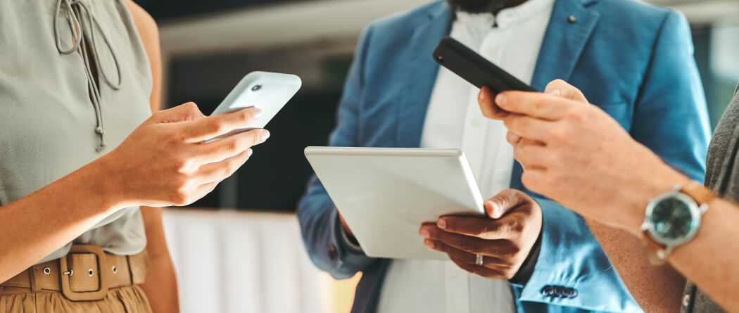 Close-up of several people using smartphones